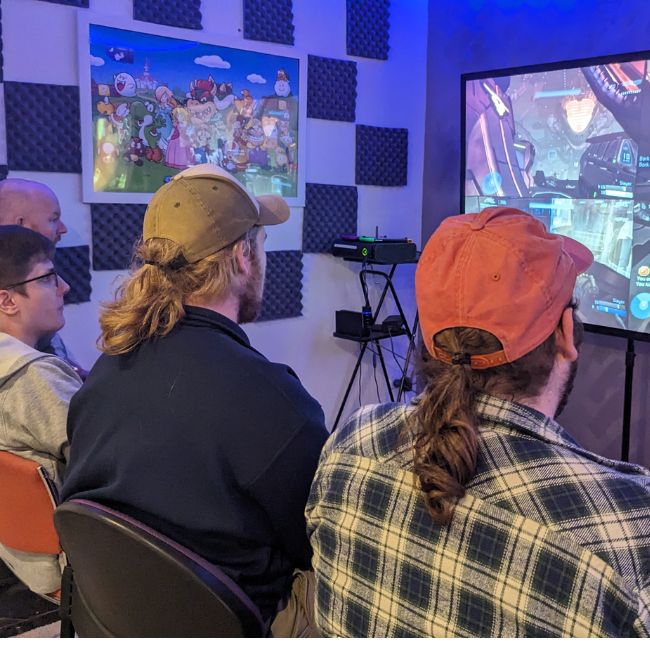 Ignition Gamers Canberra - Autism Gaming Group Canberra - Image of four young men playing a video game at ignition gamers in Canberra