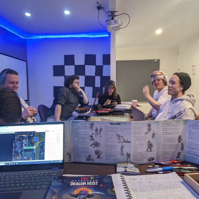 dungeons and dragons for autistic players can be beneficial. This is an image of five young men sitting around a table playing